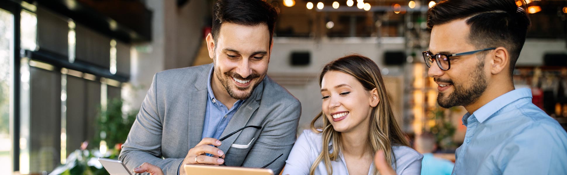 Smiling Coworkers Around Screen