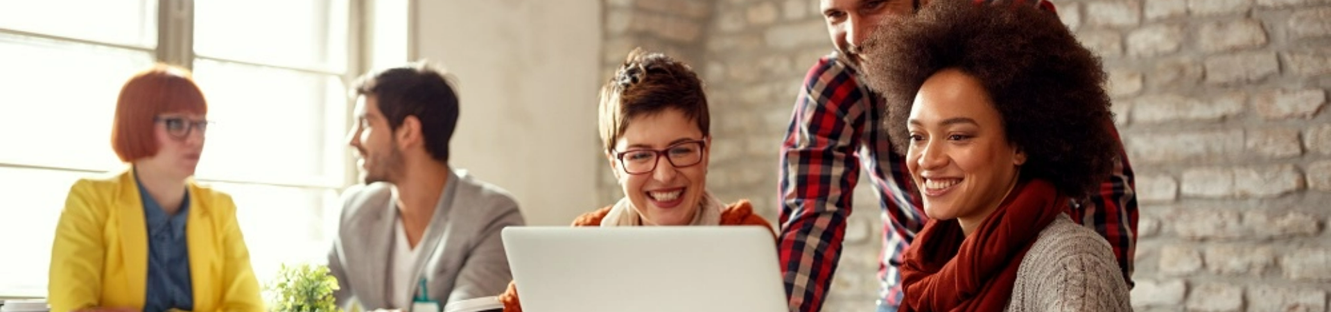 Group of people looking at laptop