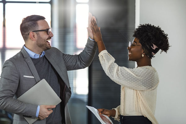 Two Businesspeople High Fiving