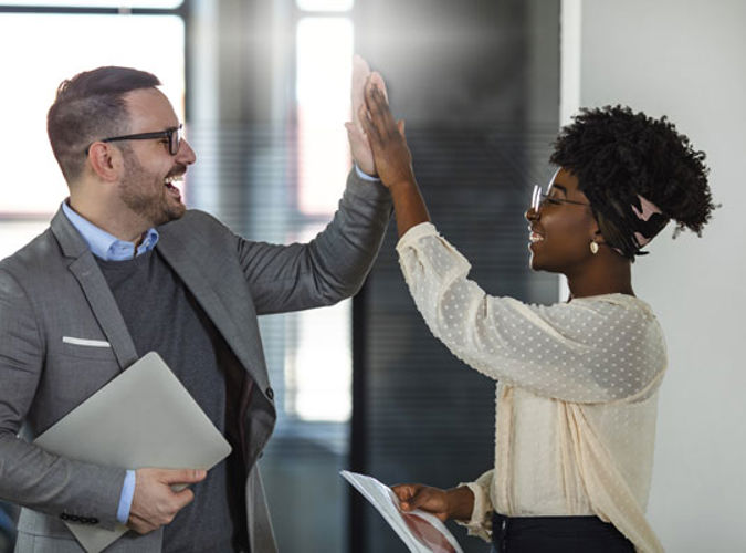 Two Businesspeople High Fiving