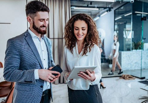 Business Man and Woman Looking at Tablet