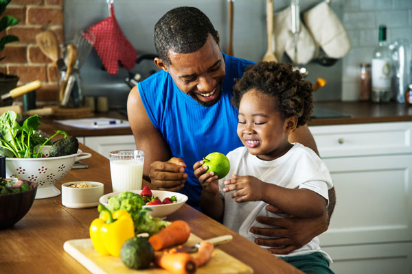 Man Feeding Child Apple