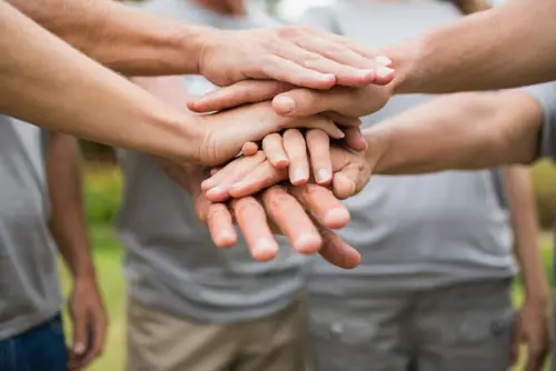 Coworker huddle with hands