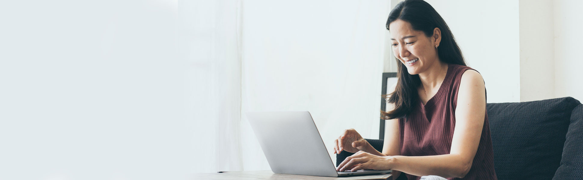 Woman smiling at laptop