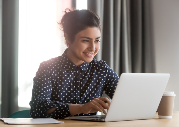 Woman Smiling At Laptop
