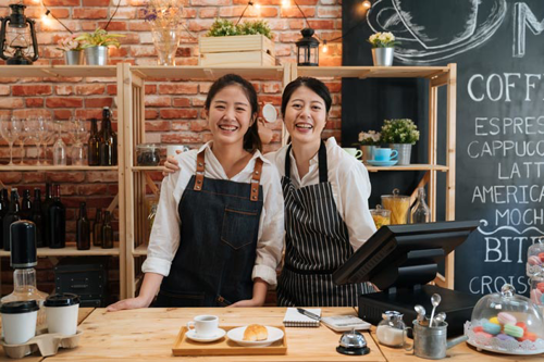 women happy at cash register